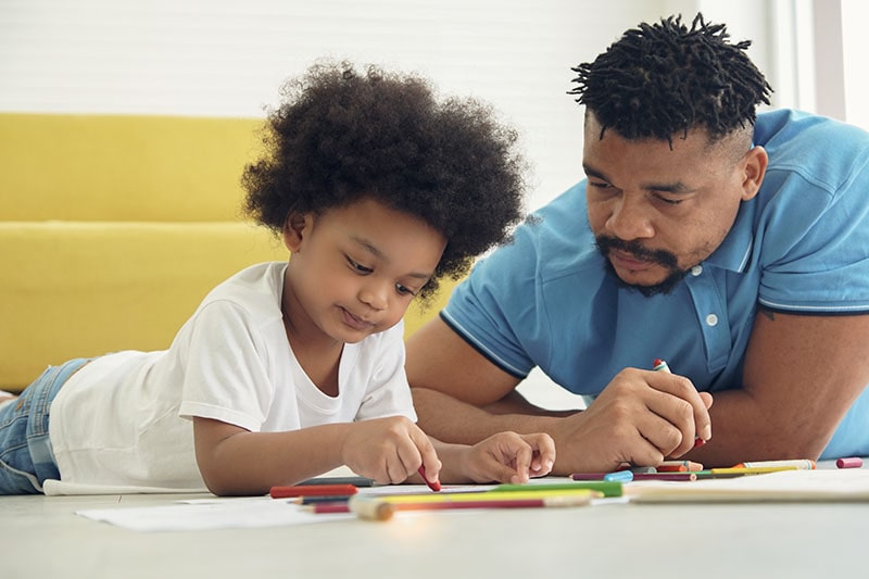 parent and child drawing with crayons