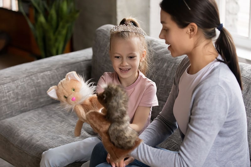 parent and child playing with stuffed animals