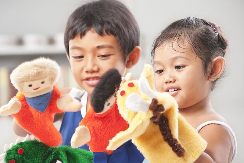 children playing with hand puppets