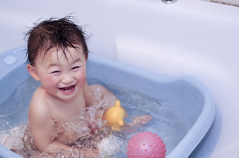 child playing in bathtub