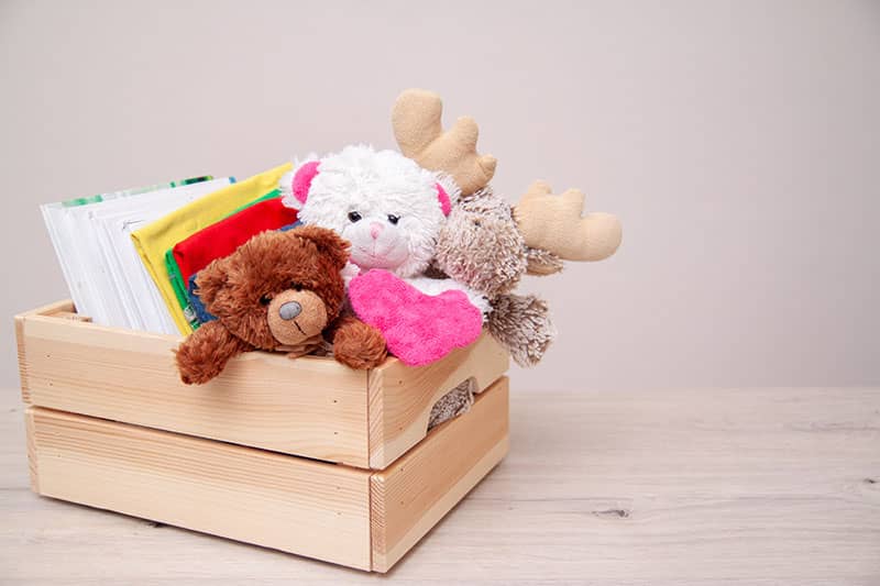 wooden crate of stuffed animals and construction paper