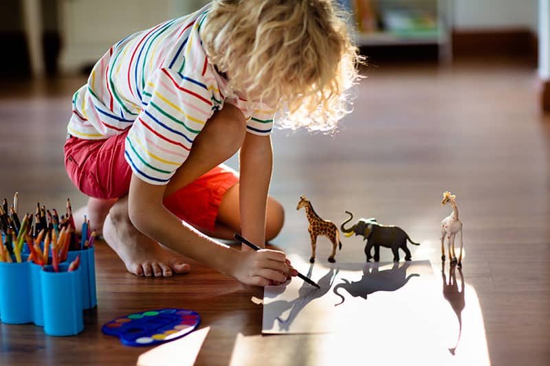 child drawing on the floor